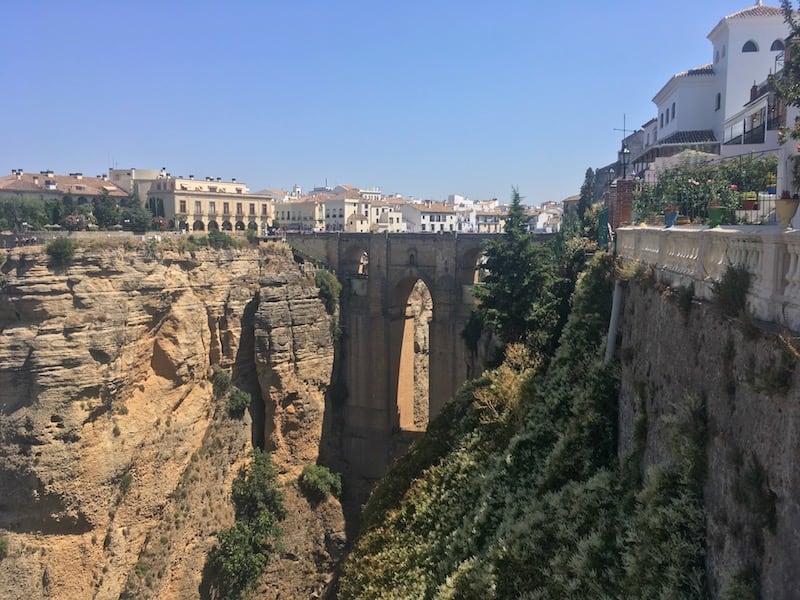 Spanish town of Ronda high on the cliffs, showing the bridge that traverses a 120m gorge joint the new & old parts of town.